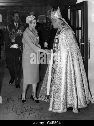 The Archbishop of Canterbury, Dr Geoffrey Fisher, receives Queen Elizabeth II and the Duke of Edinburgh on their arrival at St. Clement Danes Church, in the Strand, London. St. Clement Danes was being reconsecrated as the Church of the Royal Air Force after being restored following the damage suffered in the 1941 Blitz. Stock Photo