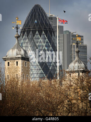 The Swiss Re building, also known as the Gherkin, and the Tower of London, are seen from Tower Bridge in London. Stock Photo