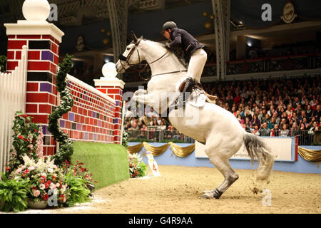 Great Britain's Guy Williams riding Richi Rich 111 Jointly wins the Alltech Christmas Puissance during the London International Horse Show at Olympia, London. Stock Photo