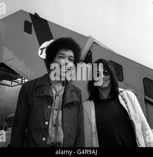 Rock guitarist Jimi Hendrix (left) with his road manager Eric Barrett at Heathrow Airport, after having flown in from New York on his way to the Isle of Wight pop festival. Stock Photo