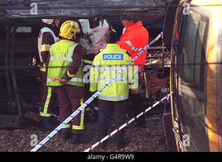 Emergency service personnel discuss the task of searching the crash wreckage of the two trains for bodies near Paddington Station, west London. The trains collided in the morning of 5/10/99, and by the evening police had reported that 26 people had died. * 28/1/2001: Police commendations awarded to heroes involved in the Paddington rail crash will be presented by the Prince of Wales this week. Twenty-two members of the public and two organisations are being honoured after they helped rescue passengers, sometimes from blazing wreckage, in the aftermath of the collision in October 1999. In Stock Photo