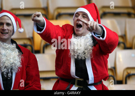 Wolverhampton Wanderers fans dressed as Father Christmas make their voices heard in the stands before the game Stock Photo
