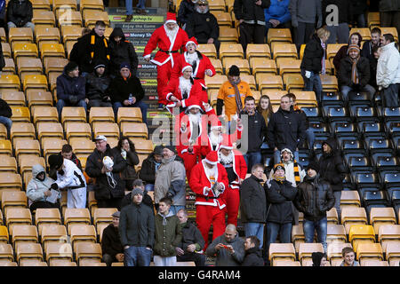 Wolverhampton Wanderers fans dressed as Father Christmas make their way to their seats in the stands before the game Stock Photo