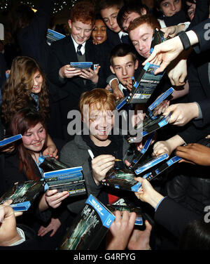 Harry Potter actor Rupert Grint signs copies of DVD's as he pays a surprise visit to Bishop Walsh RC School in Sutton Coldfield. Stock Photo