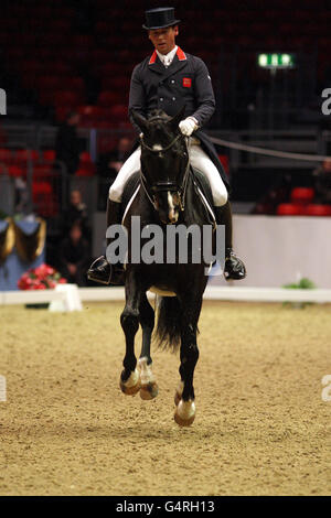 Great Britain's Carl Hester riding Uthopia competes in the Reem Acra FEI World Cup Dressage Qualifier during the London International Horse Show at Olympia, London. Stock Photo