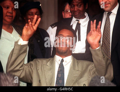 Former boxer Michael Watson celebrates outside the High Court in London after successfully winning the first round of his High Court compensation battle against the British Boxing Board of Control. * Watson suffered brain damage during his super middle-weight bout against Chris Eubank at White Hart Lane, north London, in September 1991 and is suing for damages over the events at the end of a boxing match. Stock Photo