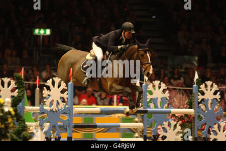 Great Britain's Guy Williams riding Djakarta wins the Kingsland Christmas Tree Stakes during the London International Horse Show at Olympia, London. Stock Photo