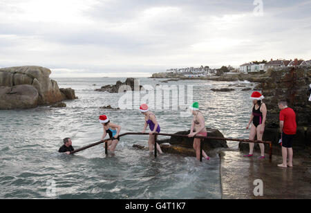 Photo. Hundreds of people at the annual Forty Foot Christmas Day Swim at Sandycove, Dublin. Stock Photo