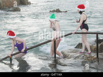 Photo. Hundreds of people at the annual Forty Foot Christmas Day Swim at Sandycove, Dublin. Stock Photo