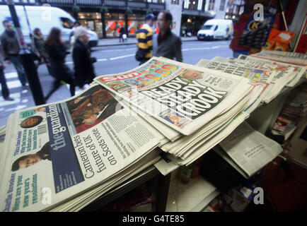 A selection of newspapers at a news stand in central London, on the day former Sun editor Kelvin MacKenzie gave evidence to the Leveson Inquiry. Stock Photo