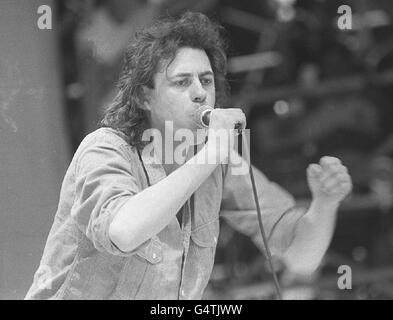 Bob Geldof sings at the Live Aid Concert at Wembley July 13, 1985. He initiated two day-long simultaneous concerts - one in England and one in America - which raised more than 50 million to aid famine relief. Stock Photo