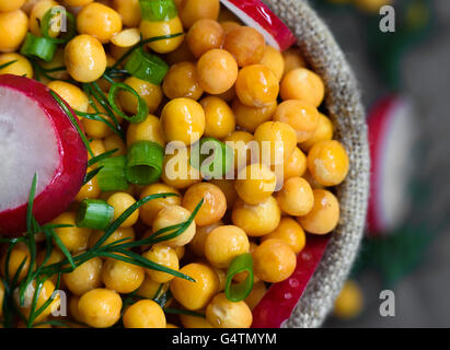 wet peas sprinkled with dill and radish Stock Photo
