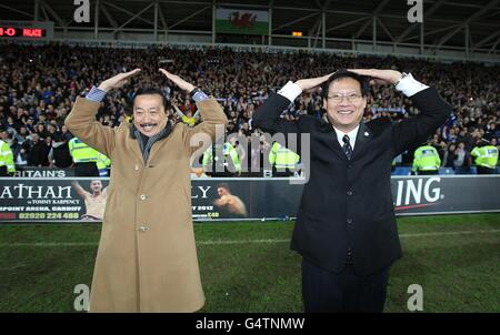 Soccer - Carling Cup - Semi Final - Second Leg - Cardiff City v Crystal Palace - Cardiff City Stadium. Cardiff City club owner Tan Sri Vincent Tan Chee Yioun (left) and chairman Chan Tien Ghee celebrate after the final whistle Stock Photo