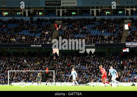 Soccer - Carling Cup - Semi Final - First Leg - Manchester City v Liverpool - Etihad Stadium. General view of empty seats in the stands during the match Stock Photo