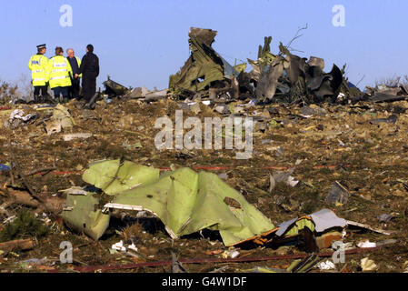 Police officers examine the site where a Korean 747 cargo jet crashed shortly after take off from Stansted Airport. The plane came down in open fields just south of the airport, killing the four crew members on board. Stock Photo