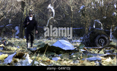 A masked accident investigator examines the site where a Korean 747 cargo jet crashed shortly after take off from Stansted Airport. The plane came down in open fields just south of the airport, killing the four crew members on board. Stock Photo