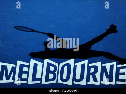 Tennis - 2012 Australian Open - Day Nine - Melbourne Park. Switzerland's Roger Federer casts a shadow onto the court during his match with Argentina's Juan Martin Del Potro Stock Photo