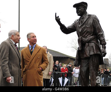 The Prince of Wales and former cricket umpire Dickie Bird look at his statue in Barnsley during a visit to the town. Stock Photo