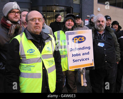 (front left to right) Branch secretary of the Public and Commercial Services union Malcolm Smith, Phil Green (holding placard), and Stephen Black (beard) as pickets prevented tax staff from going to work in Newcastle today. Stock Photo