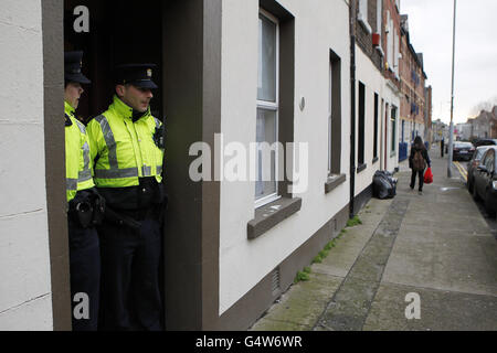 Gardai at the scene on Aughrim Street in the Stoneybatter area of north Dublin, where a flat has been sealed off for forensic examination as gardai hunt the killer of an African woman whose body was found dumped in a suitcase on Sunday. Stock Photo