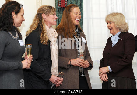 The Duchess of Cornwall (right) meets (left to right) Allison Brock, Sinead Halpin and Rebecca Howard during a reception at Clarence House, London, held in support of an animal welfare charity, The Brooke. Stock Photo
