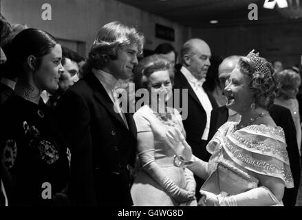 The Queen Mother talking with Ali MacGraw and Ryan O'Neal when they were presented to her at the Royal Film Performance at the Odeon Theatre, Leicester Square, London. They star in 'Love Story', the film which was being shown.