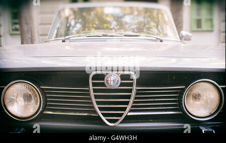 The logo of Alfa Romeo Milano on a vintage car parked in a public street. Stock Photo