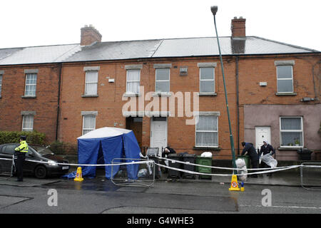 Garda and forensic officers at the scene off Blackhorse Avenue in Dublin, where the body of a woman was found murdered and dumped on the street in a suitcase. Stock Photo