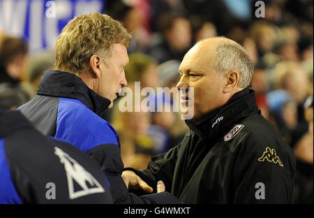 Fulham manager Martin Jol (right) and Everton manager David Moyes (left) shake hands before the match Stock Photo