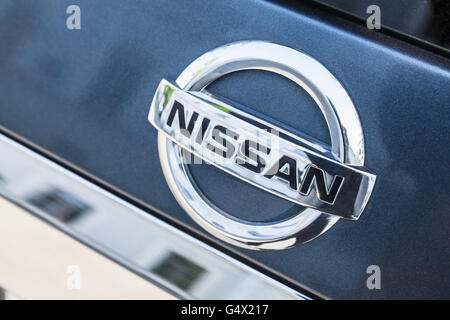 St-Petersburg, Russia - May 15, 2016: Nissan car logo mounted on rear door of Nissan X-Trail SUV, closeup photo Stock Photo