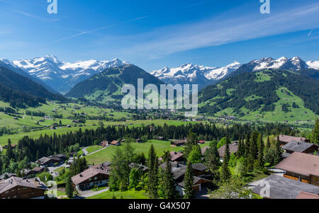 Panoramic view of Schönried and Gstaad in the Swiss Alps, surrounded by snowy mountains. Stock Photo