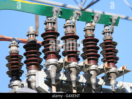 big copper busbar with high-voltage cables and insultators in an electric power plant Stock Photo