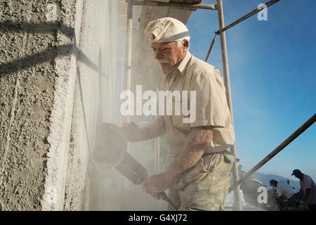 Workers build a house in Anogia, on the island of Crete in Greece Stock Photo