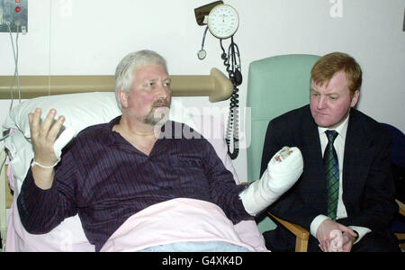 Liberal Democrat MP Nigel Jones (L), with party leader Charles Kennedy, in his bed at Cheltenham General Hospital, where he is recovering from lacerations to his hands after a sword attack in his constituency surgery in Cheltenham on 28/01/00. * A man will appear at Cheltenham magistrates court for the attempted murder of Mr Jones, and for the murder of his assistant Andrew Pennington in the same attack. Stock Photo