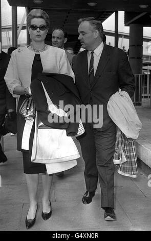 The visitor in sunglasses is Princess Grace of Monaco (formerly Grace Kelly), pictured with Prince Rainier at London Airport after their arrival by Air France. Stock Photo