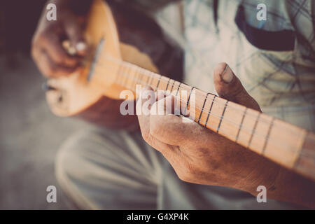 Close up shot of a man playing a Tatar instrument called 'baglama'. Stock Photo