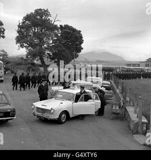 Royalty - Investiture of the Prince of Wales - Caernarfon Castle. Long lines of police march on to a local football field for a pre-investiture briefing in Caernarfon. Stock Photo