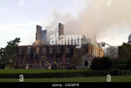 Firefighters outside the home of Tory MP Michael Colvin after fire swept through his country mansion in Tangley, near Andover. Rescuers are searching for Mr Colvin and his wife Nichola in the remains of the house, which has been 95% destroyed. Stock Photo