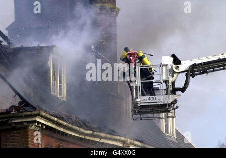 Firefighters hose down the home of Tory MP Michael Colvin after fire swept through his country mansion in Tangley, near Andover. Rescuers are searching for Mr Colvin and his wife Nichola in the remains of the house, which has been 95% destroyed. Stock Photo