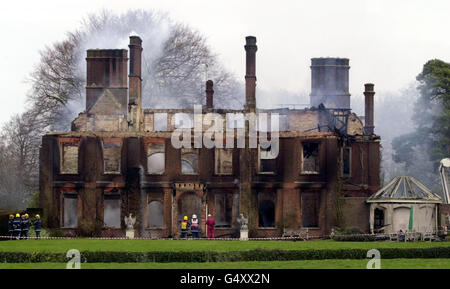 Firefighters at the home of Conservative MP Michael Colvin. Rescuers were searching for Mr Colvin and his wife Nichola at the country mansion after a fire gutted their home, Tangley House in the village of Tangley, near Andover in Hampshire. * It was swept by flames fanned by high winds in the early hours. About 70 firefighters and 10 fire appliances were still at the scene damping down the house which has been 95% destroyed. Stock Photo