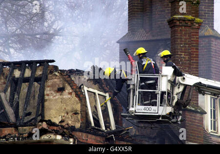 Firefighters at the home of Conservative MP Michael Colvin. Rescuers were searching for Mr Colvin and his wife Nichola at their country mansion after a fire gutted their home, Tangley House in the village of Tangley, near Andover in Hampshire. * It was swept by flames fanned by high winds in the early hours. About 70 firefighters and 10 fire appliances were still at the scene damping down the house which has been 95% destroyed. Stock Photo