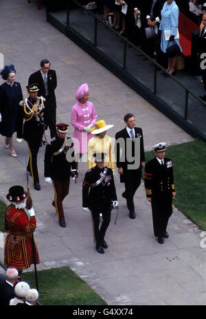 Headed by officials, Princess Alexandra (in yellow) and her husband Angus Ogilvy, right, and Prince Prince Michael of Kent, left, followed by the Duke and Duchess of Kent, and the Duchess of Gloucester and Prince Richard of Gloucester, arriving for the investiture of the Prince of Wales at Caernarfon Castle Stock Photo