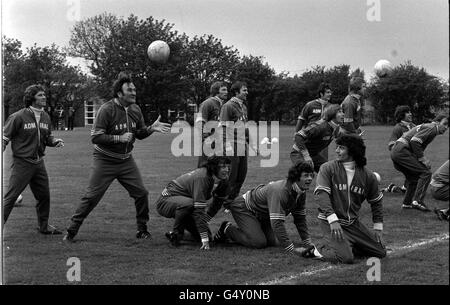 England soccer manager Don Revie (second left) watches his team train. (l/r) Alan Ball, Mike Channon (kneeling), Colin Todd (standing), Ian Gilliard (kneeling), Trevor Francis, Colin Bell, David Nish and Kevin Keegan, (kneeling). *The team were traning in preparation for the Home International Championship. Stock Photo