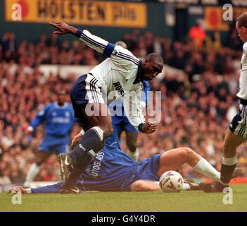 Tottenham Hotspur defender Sol Campbell (centre) skips around a fallen Chelsea player, during their FA Premiership football match at White Hart Lane, London. Stock Photo