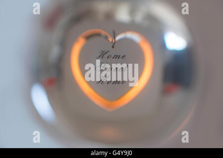 Home Sweet Home candle holder reflected in a crystal ball Stock Photo