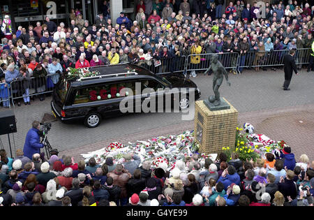 Sir Stanley Matthews' funeral cortege pauses at his statue in the centre of Hanley, in Stoke, as around 100,000 people were expected to line the route of the Stoke City football legend's final journey through his beloved city. * The funeral cortege began from the Britannia Stadium at 11.30am before winding its way through the Potteries to St Peter's Church. Stock Photo