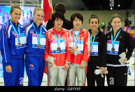 Great Britain's Tonia Couch (left) and Sarah Barrow celebrate with their medals after finishing third, alongside gold medal winners China's Chen Ruolin and Wang Ho and Silver medalists from Canada Meaghan Benfeito and Roseline Filion following their Women's Synchronised 10m Platform Final during the 18th FINA Visa Diving World Cup at the Aquatics Centre in the Olympic Park, London. Stock Photo