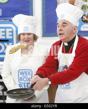Singer Susan Boyle and Catholic Church leader Cardinal Keith O'Brien flip pancakes at St Augustine's High School in Edinburgh, during the launch of SCIAF's Wee Box, Big Change fundraising campaign. Stock Photo