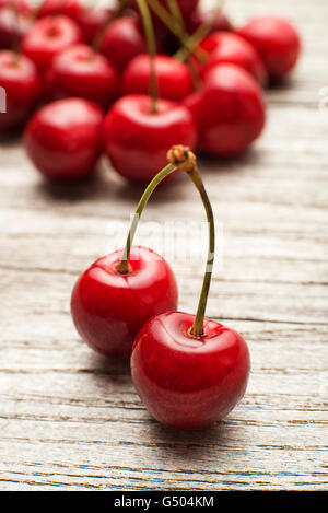 Fresh cherries on wooden table close up. Stock Photo