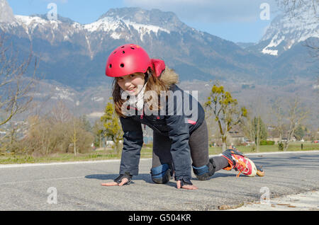 a pretty preteen girl on roller skates in helmet Stock Photo